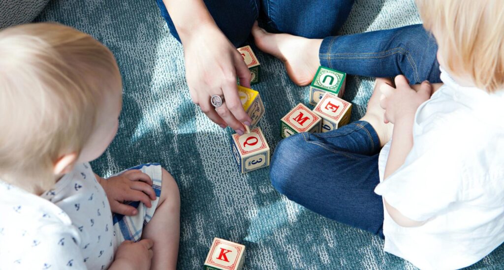 children playing on floor with blocks